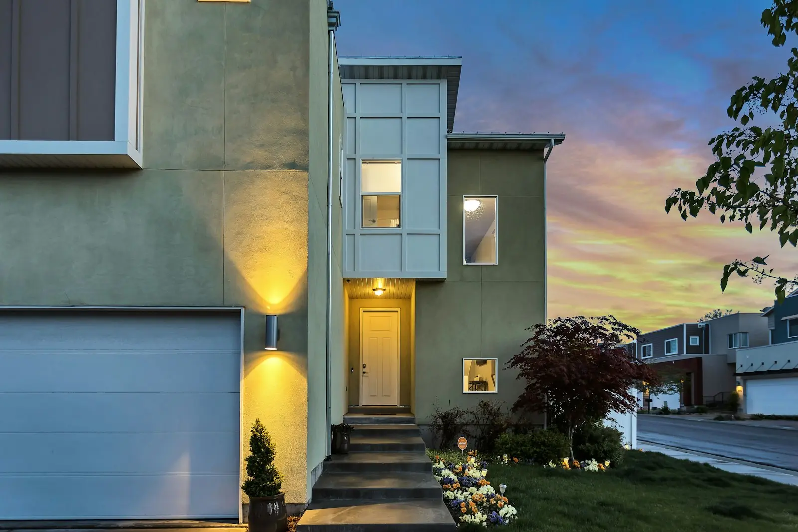 Warmly lit modern home at twilight