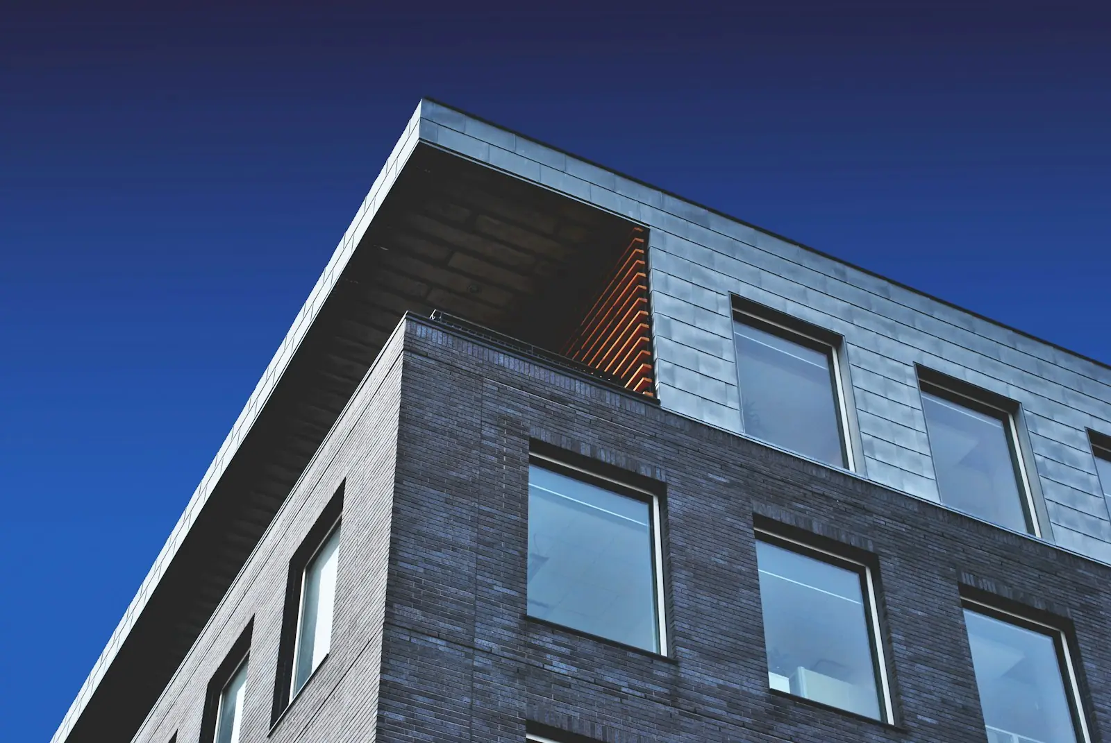 Detail of a contemporary residential facade against a clear sky